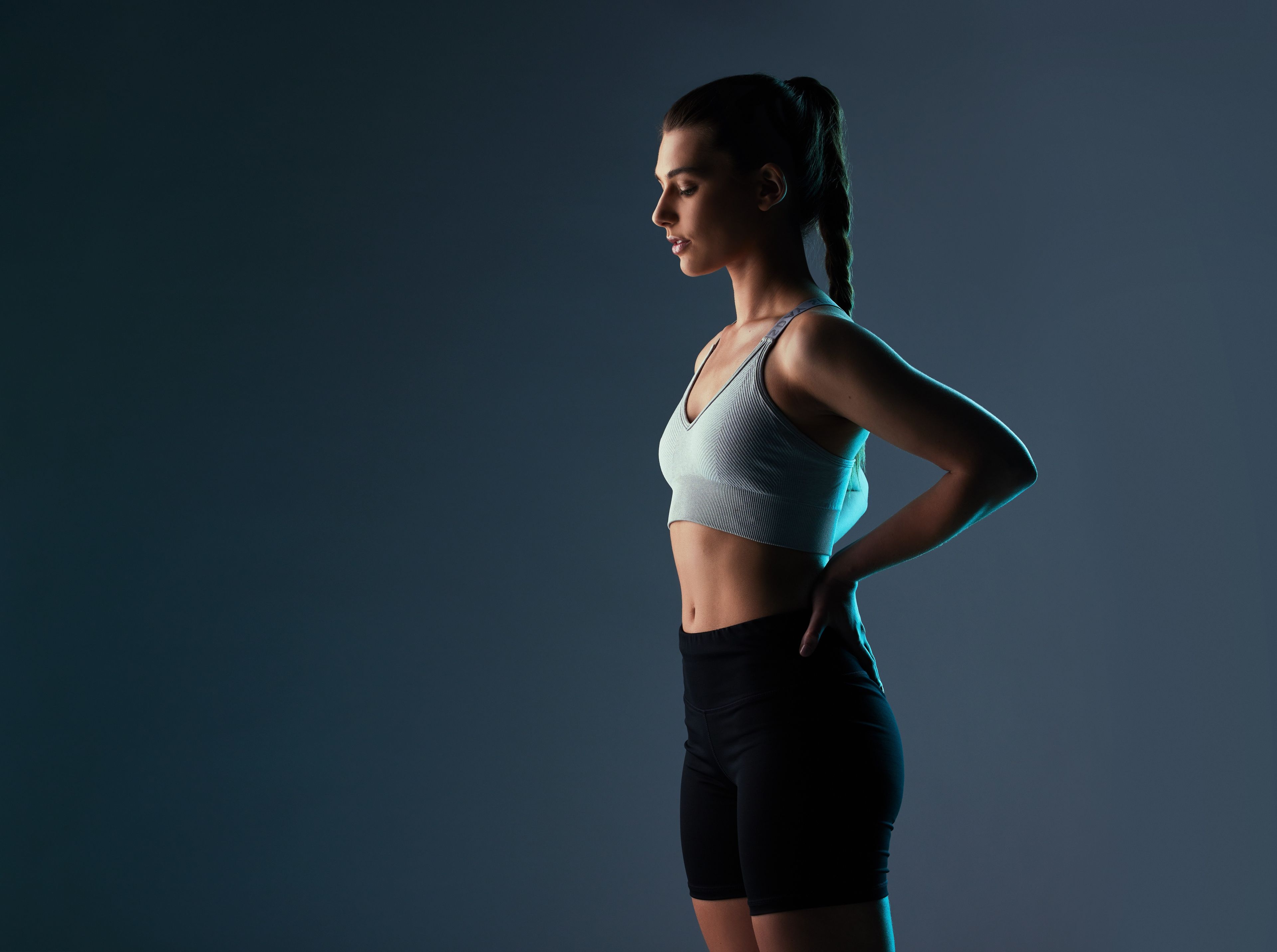 Woman in gym attire with hands on hips