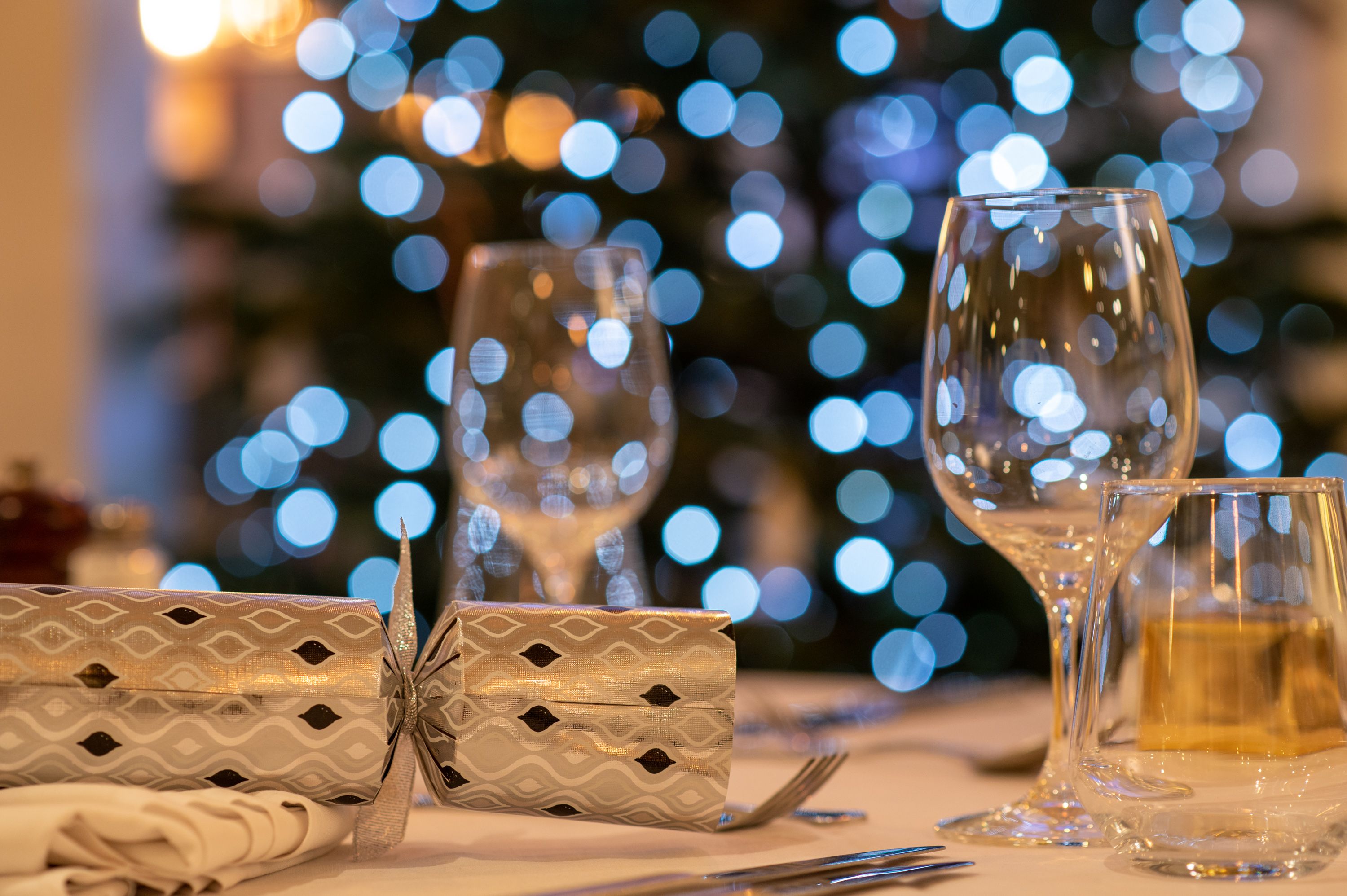 Dining table in front of twinkling Christmas tree