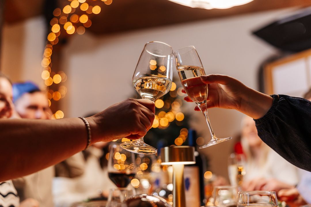 Cheersing wine over the table