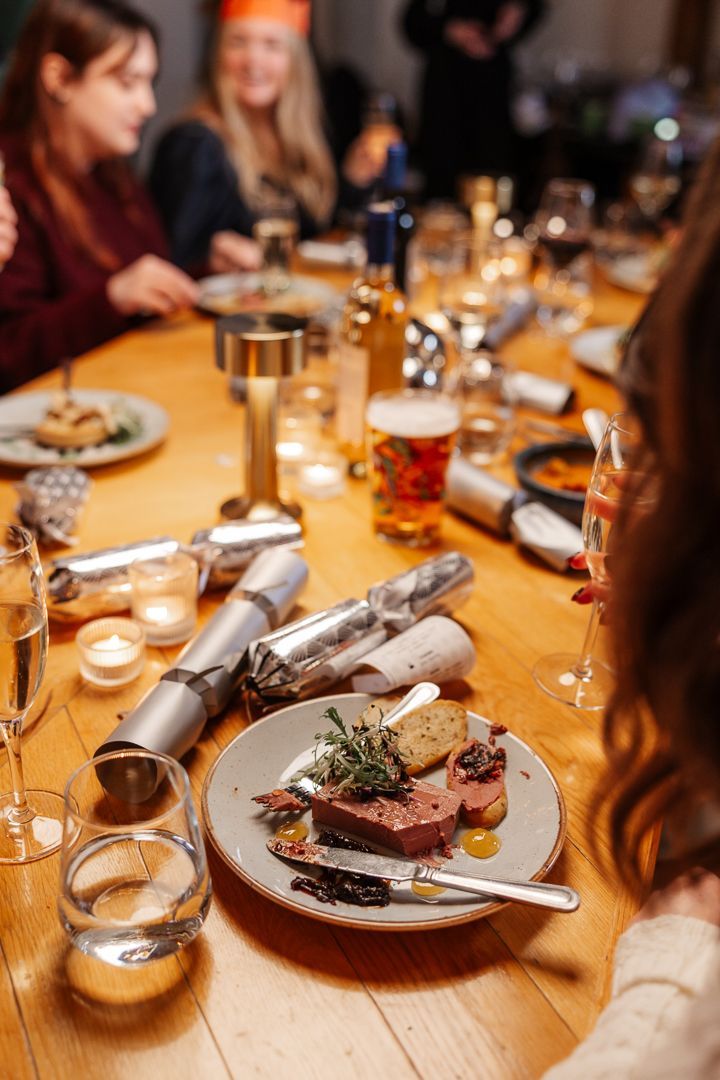 Group dining with drinks and crackers on table
